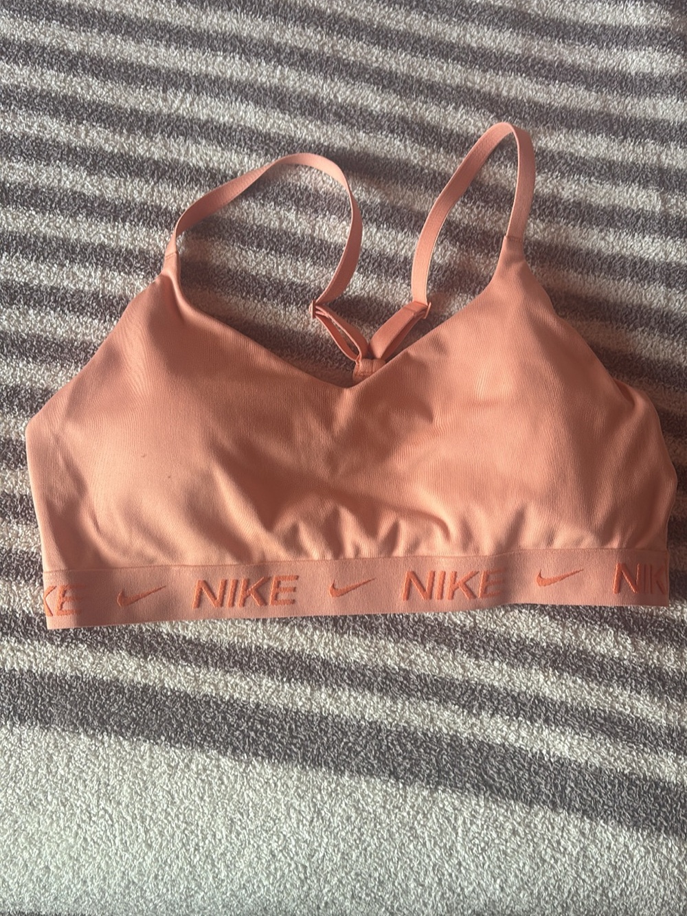 Nike Women’s Indy light support padded adjustable sports bra in Peach